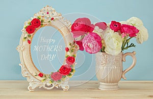 spring flowers next to photo frame. Mothers day concept