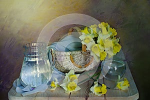 Spring flowers.Still life of yellow daffodils in a wicker basket, isolated on light yellow background