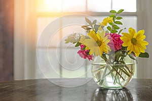 Spring flowers on table in vase with dark greys and blacks with