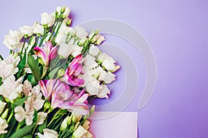 Spring flowers. Women's day purple background. Bouquet of white and pink eustoma. Present gift for Mother's day