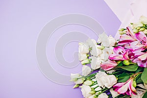 Spring flowers. Women's day purple background. Bouquet of white and pink eustoma. Present gift for Mother's day