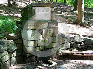 Spring in the forest made up of stones