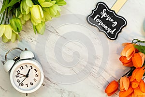 Spring Forward Daylight Saving Time concept with text on marble flat lay