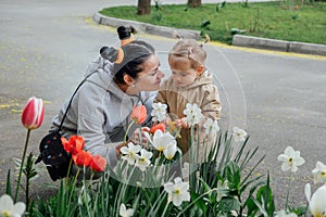 Spring Gardening activities for toddler kids. Senior woman grandmother and little toddler girl granddaughter watering