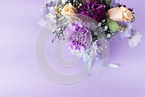 A spring gentle bouquet of mixed flowers on a purple background. First meeting bouquet or 8 of march concept
