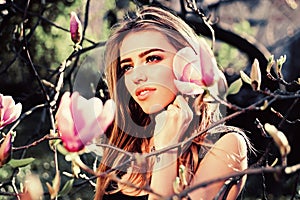 Spring girl in blooming garden. Magnolia. Summer girl and sensual moment. Beauty woman outdoors in blooming trees