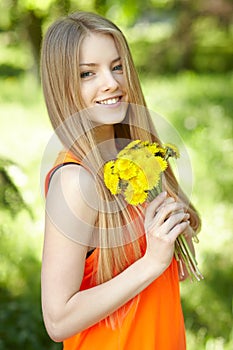 Spring girl with bunch of dandelions