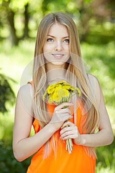 Spring girl with bunch of dandelions