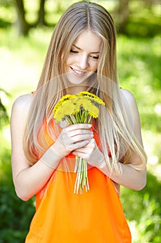 Spring girl with bunch of dandelions