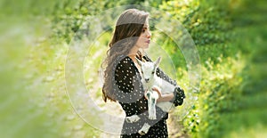 Spring girl with lamb. Goat milk. Sensual woman with goat. Animal, countryside. Beauty young woman enjoying nature in