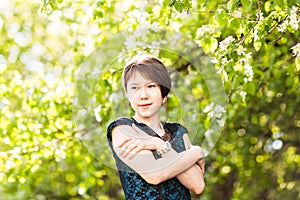 Spring girl outdoor portrait in blooming trees. Beauty Romantic woman in flowers. Sensual Lady. Beautiful Woman
