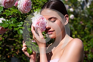 Spring girl. Young woman enjoying blooming spring garden. The concept of youth, love, fashion and lifestyle. Beautiful