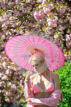 Spring girls fashion in bra on Cherry blossom Spring park. Dream woman.
