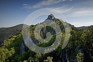 Spring green mountain landscape with unique rock towers. View of a green valley with forests and rocks. The Sulov Rocks, national