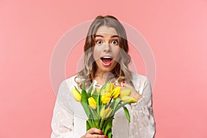 Spring, happiness and celebration concept. Close-up of surprised and wondered young blond girl in white dress, receive