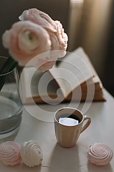 Spring home interior decor. Coffee cup, flowers, book. Concept of holiday, birthday. Blog, website or social media concept