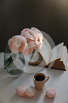 Spring home interior decor. Coffee cup, flowers, book. Decorated interior in living room. Blog, website or social media concept
