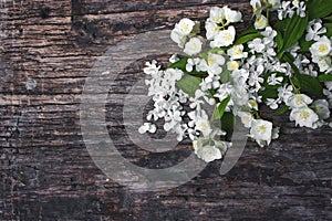 Spring jasmine flowers on wooden background. Valentine`s day greeting card Copy space Top view