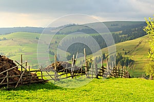 Spring landscape in the Carpathian mountains with fence