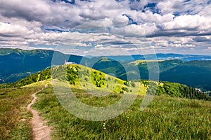 Spring landscape with grassy meadows and the mountain peaks