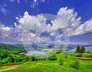 Spring landscape in mountains with lake.