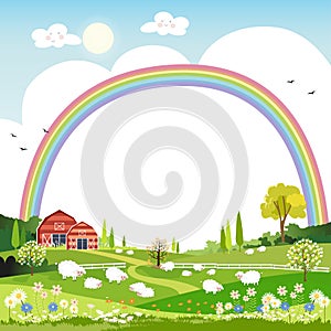 Spring landscape with rainbow,blue sky and clouds with raining, goats and sheep on green fields with copy space,Nature spring or