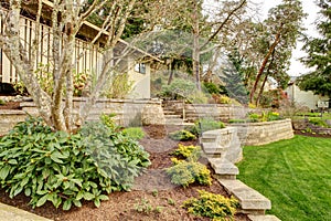 Spring Landscape with retaining walls and garage. photo