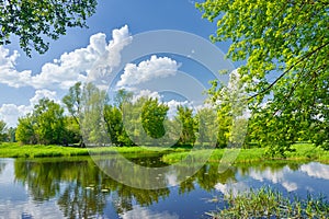 Spring landscape river clouds blue sky green trees