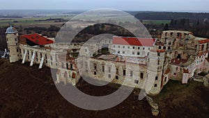Spring landscape with ruined medieval Janowiec Castle on hilltop above village of same name, Poland