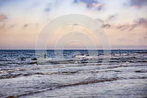 Spring landscape from the shore of the Baltic Sea in the blue sky and an angler