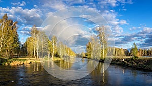 Spring landscape at the Ural river with birch, Russia