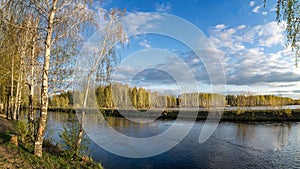 Spring landscape at the Ural river with birch, Russia