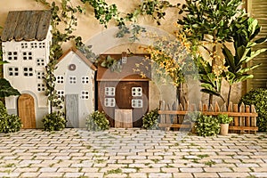 Spring little houses with paviment and cute lights, and yellow flowers photo
