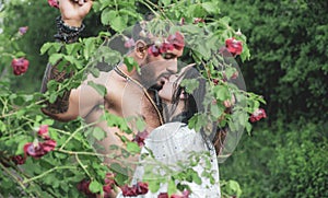 Spring lovers in blooming garden. Lovely spring couple kiss and hugs. Summer couple and erotic moment. Couple outdoors