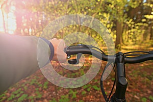 Spring man riding a bicycle in the woods outdoors close up.