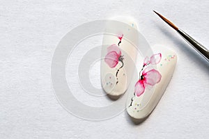 Spring manicure. Tips with spring flower design on a white background