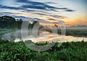 Morning. a picturesque foggy dawn by the river. Sun rays