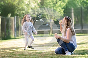 Spring, mother with daughter playing outdoors