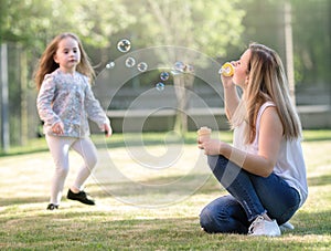 Spring, mother with daughter playing outdoors