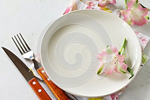 Spring or Mother`s Day table setting. Plate, cutlery and napkin