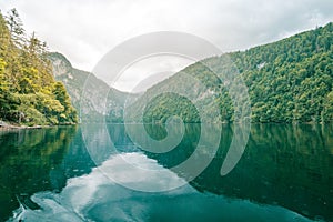 Spring mountain lake landscape and reflection. Alpine nature with morning haze, relax scenic view, natural view