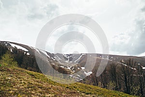 Spring in mountains. Beautiful mountain landscape with snow on the north slope photo