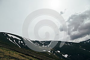 Spring in mountains. Beautiful mountain landscape with snow on the north slope