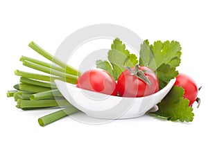 Spring onions and cherry tomato in bowl