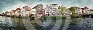 Spring panorama of Strasbourg city in front of Quai des Bateliers street along water canal. Fachwerk timber framing colorful