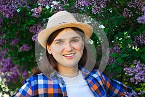 Spring people. Defocus beautiful young woman near blooming spring tree. Bush lilac flowers. Youth, love, fashion