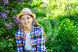 Spring person. Defocus beautiful young woman near blooming spring tree. Bush lilac flowers. Youth, love, fashion