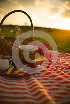 Spring picnic basket on sunset