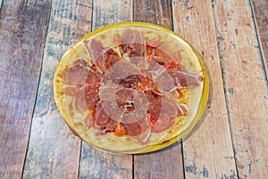 Spring pizza with gluten-free flour dough, cherry tomatoes and tomato slices