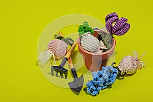 Spring planting and gardening concept. Handmade flowers with bulbs, mini tools, watering can, buckets